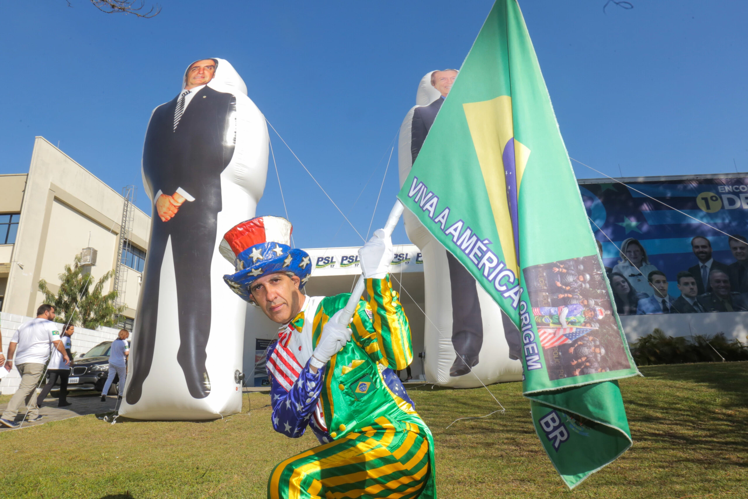 Participante em frente ao local do evento do PSL, onde foram inflados dois bonecos gigantes com os rostos de Jair Bolsonaro e do presidente nacional do partido, Luciano Bivar.