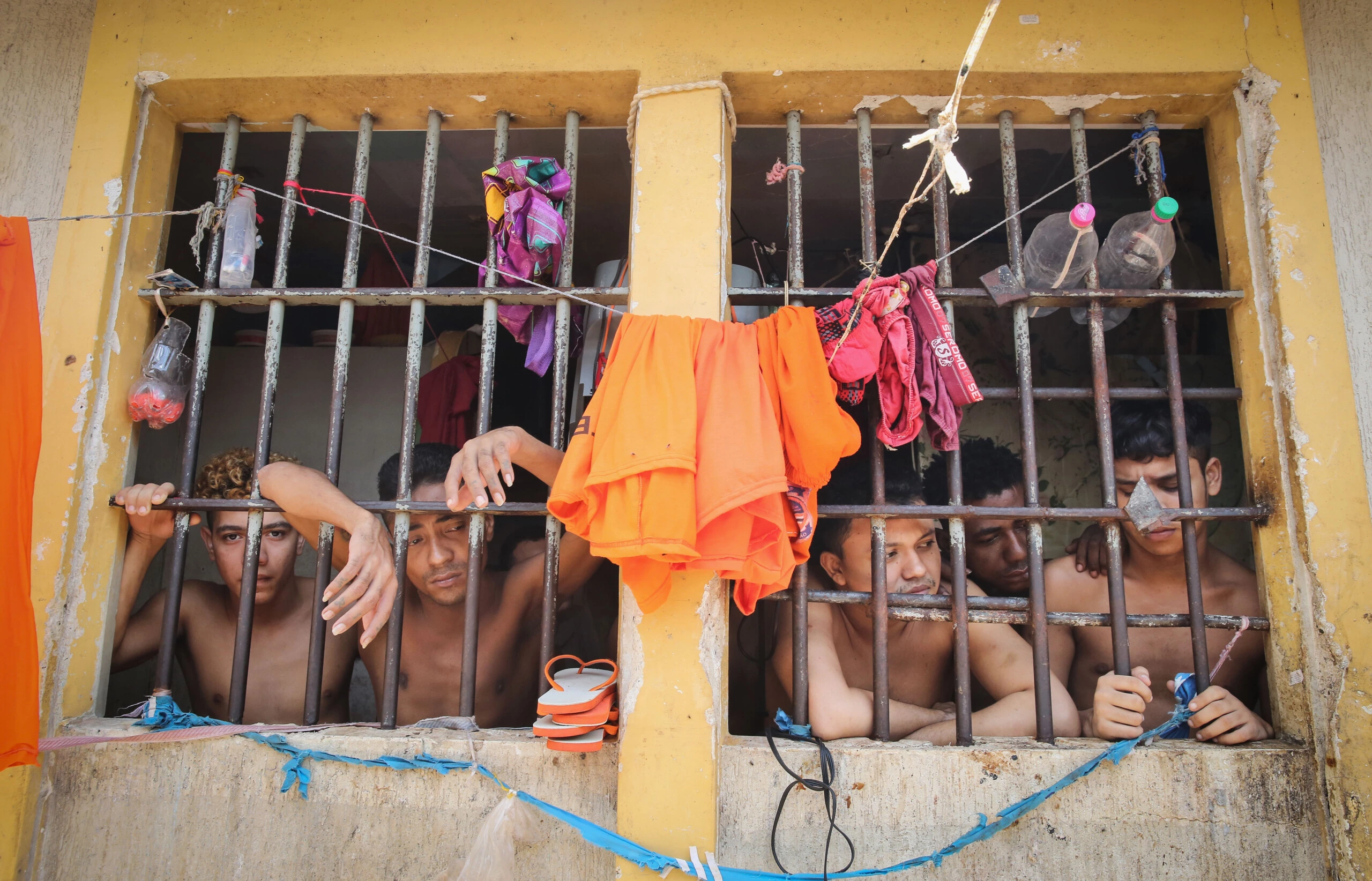 SAO LUIS, BRAZIL - JANUARY 27:  Inmates stand in their cell in the Pedrinhas Prison Complex, the largest penitentiary in Maranhao state, on January 27, 2015 in Sao Luis, Brazil. Previously one of the most violent prisons in Brazil, Pedrinhas has seen efforts from a new state administration, new prison officials and judiciary leaders from Maranhao which appear to have quelled some of the unrest within the complex. In 2013, nearly 60 inmates were killed within the complex, including three who were beheaded during rioting. Much of the violence stemmed from broken cells allowing inmates and gang rivals to mix in the patios and open spaces of the complex. Officials recently repaired and repopulated the cells allowing law enforcement access and decreasing violence among prisoners, according to officials. Other reforms include a policy of custody hearings and real-time camera feeds. According to officials there have been no prisoner on prisoner killings inside the complex in nearly four months. Critics believe overcrowding is one of the primary causes of rioting and violence in Brazil's prisons. Additionally, overcrowding has strengthened prison gangs which now span the country and contol certain peripheries of cities including Rio de Janeiro, Sao Paulo and Sao Luis. Brazil now has the fourth-largest prison population in the world behind the U.S., Russia and China. The population of those imprisoned had quadrupled in the past twenty years to around 550,000 and the country needs at least 200,000 new incarceration spaces to eliminate overcrowding. A vast increase in minor drug arrests, a dearth of legal advice for prisoners and a lack of political will for new prisons have contributed to the increases.  (Photo by Mario Tama/Getty Images)