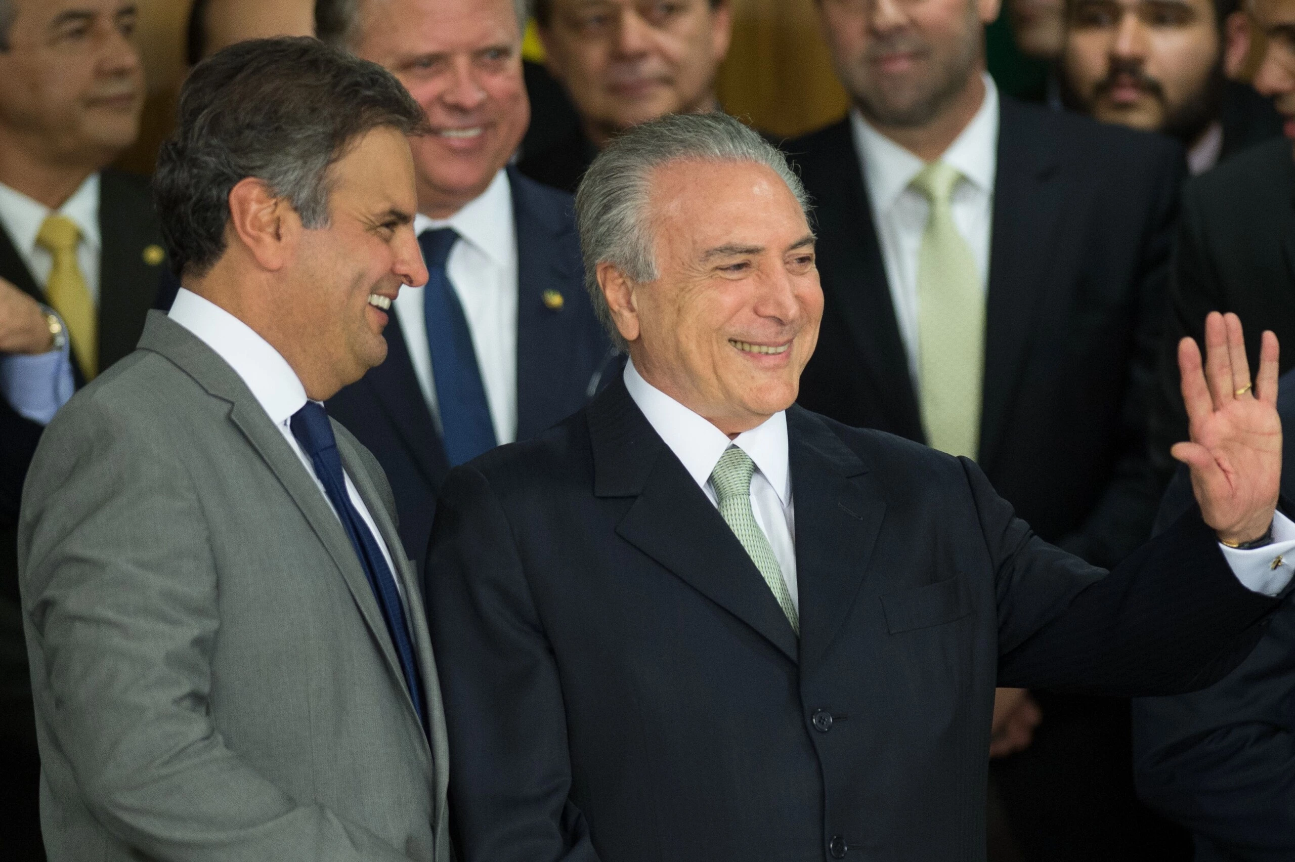 Brazilian acting President Michel Temer (R) and Senator Aecio Neves during the new ministers inauguration ceremony at Planalto palace in Brasilia, on May 12, 2016. Temer said Thursday his new cabinet must work to restore the country's "credibility," in his first address after assuming power from suspended predecessor Dilma Rousseff pending her impeachment trial. / AFP / ANDRESSA ANHOLETE        (Photo credit should read ANDRESSA ANHOLETE/AFP/Getty Images)