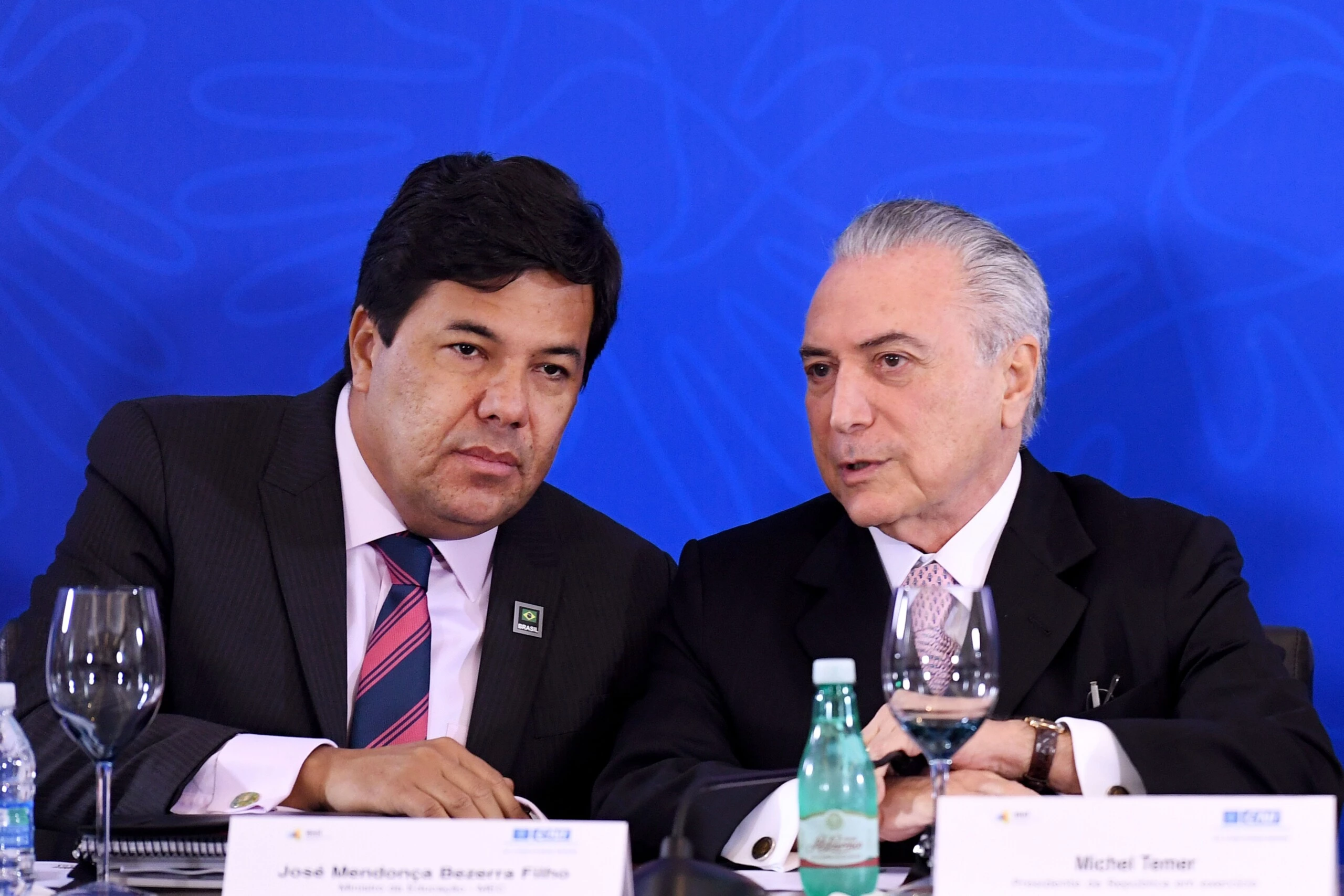 Brazilian acting President Michel Temer (R) speaks with his Education Minister Jose Mendonca Filho during a meeting with the Business Leaders Mobilization for Innovation Committee at the National Industry Confederation building in Brasilia on July 8, 2016. / AFP / EVARISTO SA        (Photo credit should read EVARISTO SA/AFP/Getty Images)