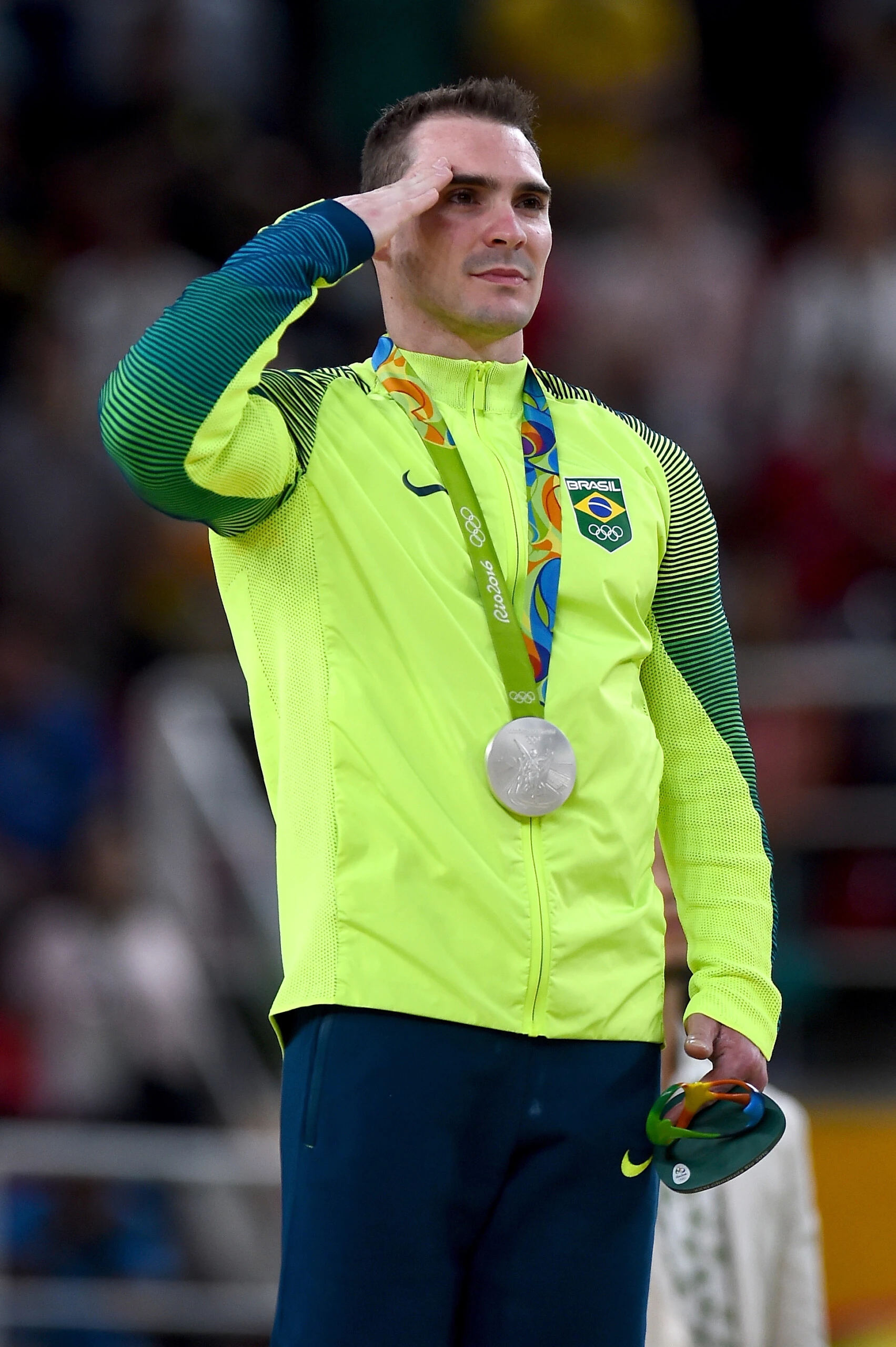 RIO DE JANEIRO, BRAZIL - AUGUST 15:  Silver medalist Arthur Zanetti of Brazil salutes during the national anthem on the podium at the medal ceremony for Men's Rings on day 10 of the Rio 2016 Olympic Games at Rio Olympic Arena on August 15, 2016 in Rio de Janeiro, Brazil.  (Photo by Laurence Griffiths/Getty Images)