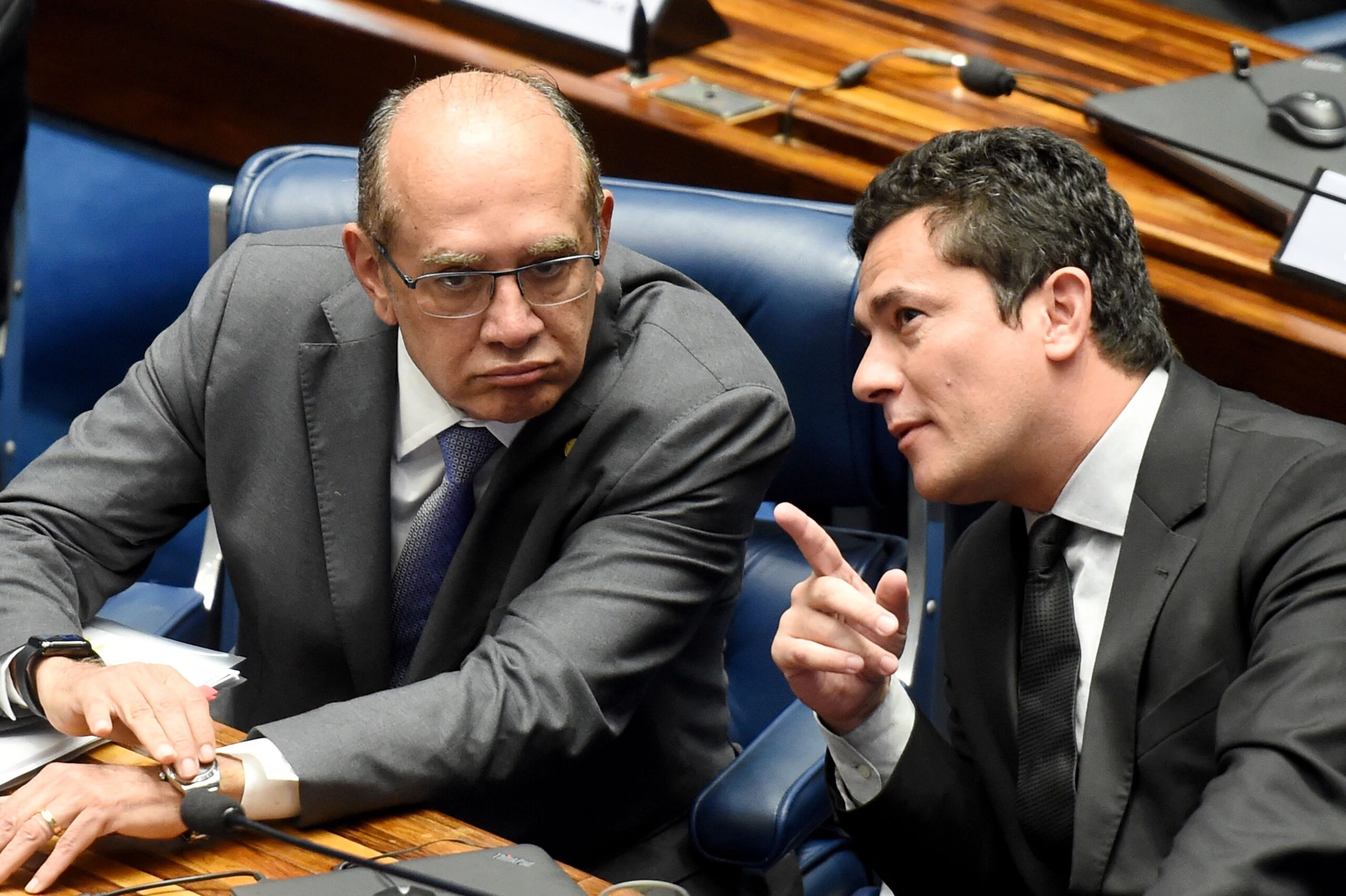 Supreme Court's Judge Gilmar Mendes (L) listens to Federal Judge Sergio Moro during a public hearing on the bill that establishes the abuse of authority for judges and prosecutors, in the Senate in Brasilia on December 1, 2016.<br /> Even with a strong reaction against the bill from the public, Calheiros tries to speed up approval in the Senate and Lower House. The controversial law is ostensibly meant to crack down on undeclared election campaign funds, a common practice in Brazilian politics that has been linked to large-scale corruption. Judges and prosecutors have branded this as a weapon to reduce the judiciary's independence. / AFP / EVARISTO SA        (Photo credit should read EVARISTO SA/AFP/Getty Images)