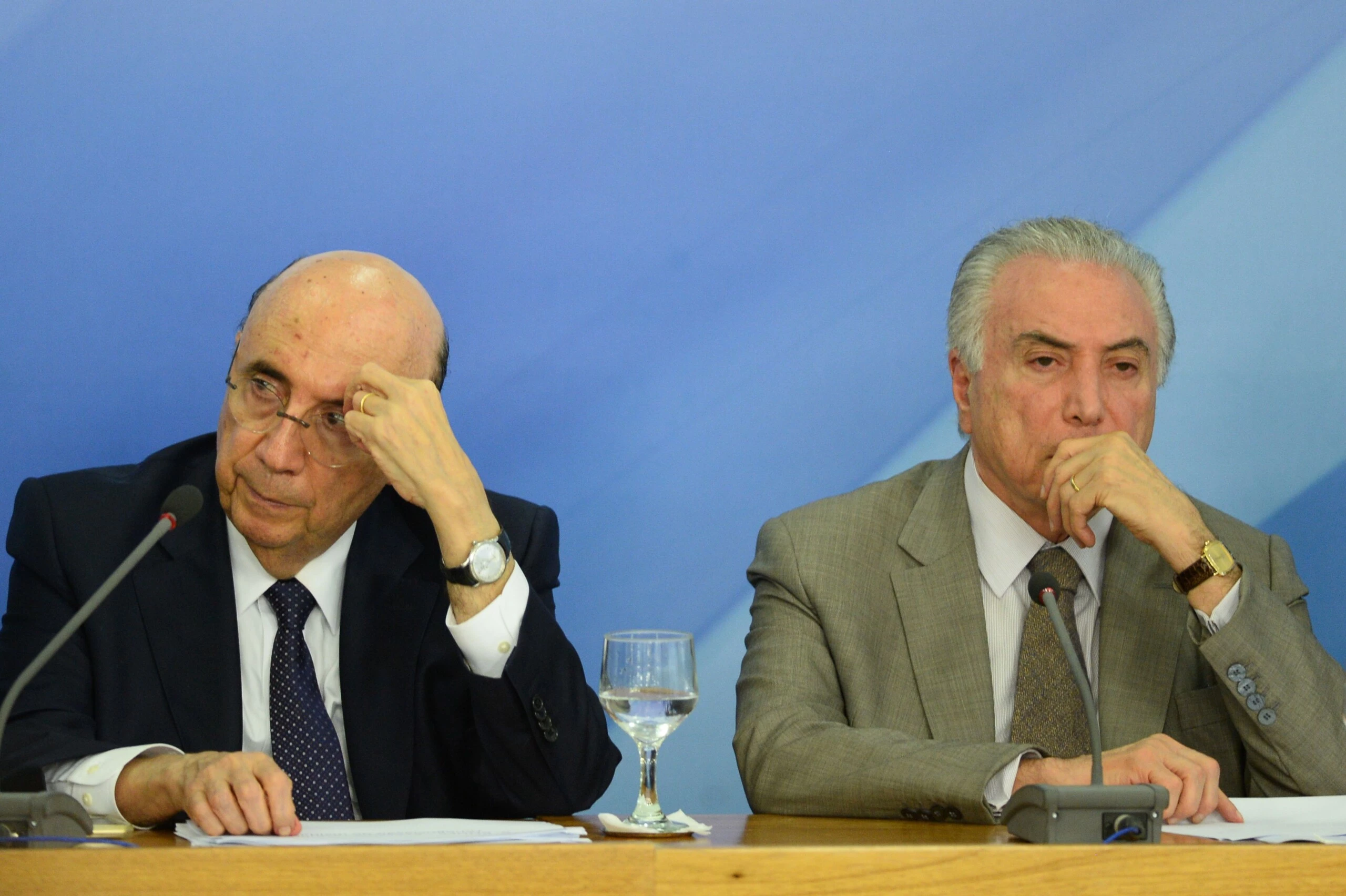 Brazilian President Michel Temer (R) and Finance Minister Henrique Meirelles (L) gesture during the announcement of new measures to stimulate the economy, in the Planalto Palace on December 15, 2016 in Brasilia. / AFP / ANDRESSA ANHOLETE        (Photo credit should read ANDRESSA ANHOLETE/AFP/Getty Images)