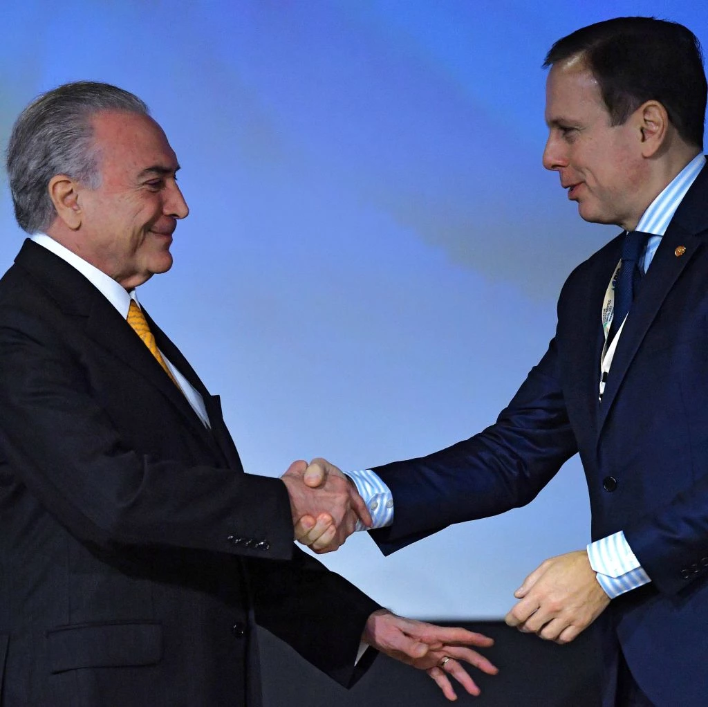 Sao Paulo's mayor Joao Doria (R) shakes hands with Brazilian President Michel Temer, during an Investment Forum in Sao Paulo, Brazil on May 30, 2017. / AFP PHOTO / NELSON ALMEIDA        (Photo credit should read NELSON ALMEIDA/AFP/Getty Images)