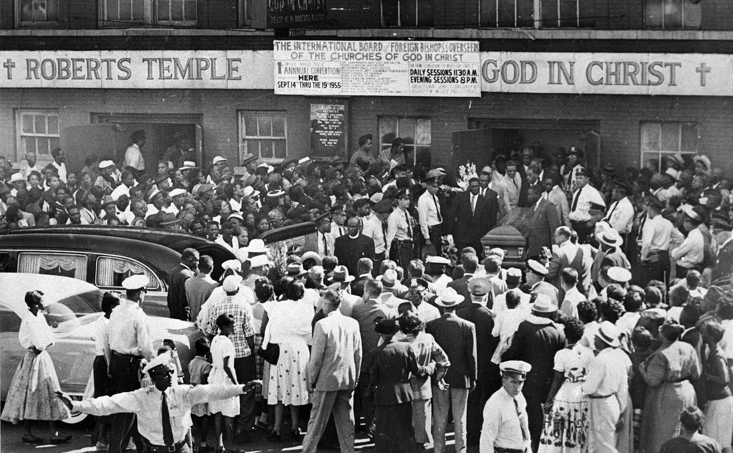 A large crowd gathers outside the Roberts Temple Church of God In Christ in Chicago, Ill.,  Sept. 6, 1955 as pallbearers carry the casket of Emmett Till, a 14-year-old African-American boy who was slain while on a visit to Mississippi. Police estimate a crowd of about 2,000.  (AP Photo)