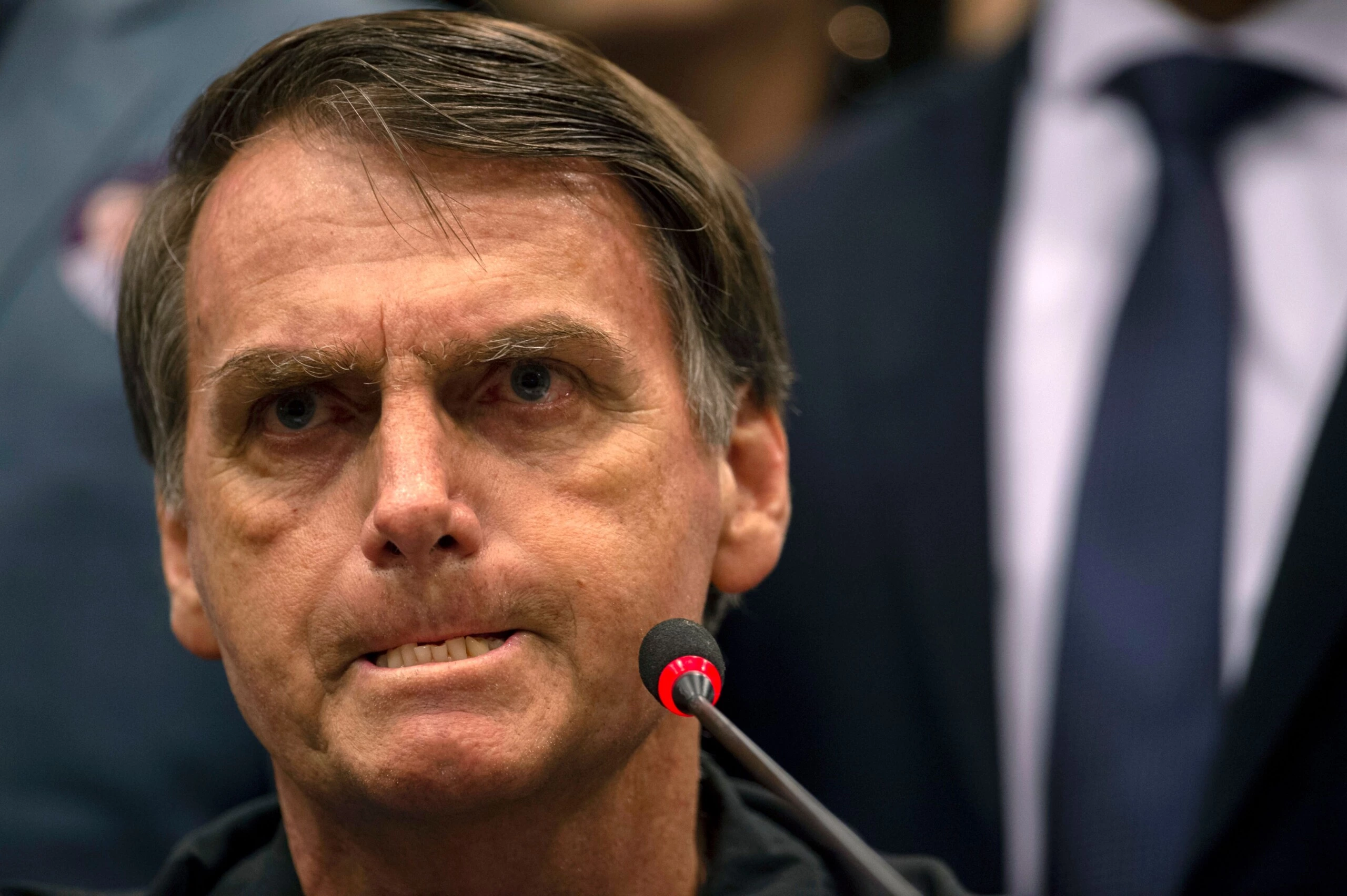 TOPSHOT - Brazil's right-wing presidential candidate for the Social Liberal Party (PSL) Jair Bolsonaro gestures during a press conference in Rio de Janeiro, Brazil on October 11, 2018. - The far-right frontrunner to be Brazil's next president, Jair Bolsonaro, stumbled othe eve by spooking previously supportive investors, while a spate of violent incidents pointed to deep polarization caused by the election race. (Photo by Mauro Pimentel / AFP)        (Photo credit should read MAURO PIMENTEL/AFP/Getty Images)