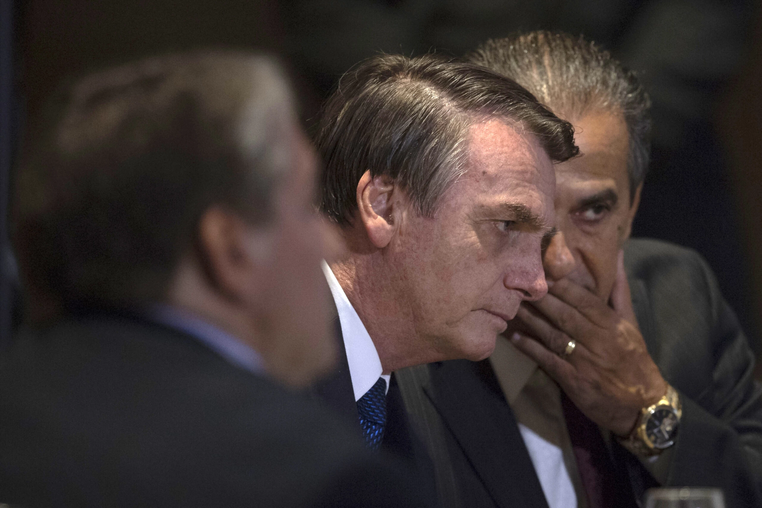 Brazilian President Jair Bolsonaro speaks with Brazilian Congressman and Bishop Silas Malafaia (R) during a meeting with evangelical leaders at the Hilton Barra Hotel, in Barra da Tijuca neighborhood, Rio de Janeiro, Brazil on April 11, 2019. (Photo by Mauro Pimentel / AFP)        (Photo credit should read MAURO PIMENTEL/AFP via Getty Images)