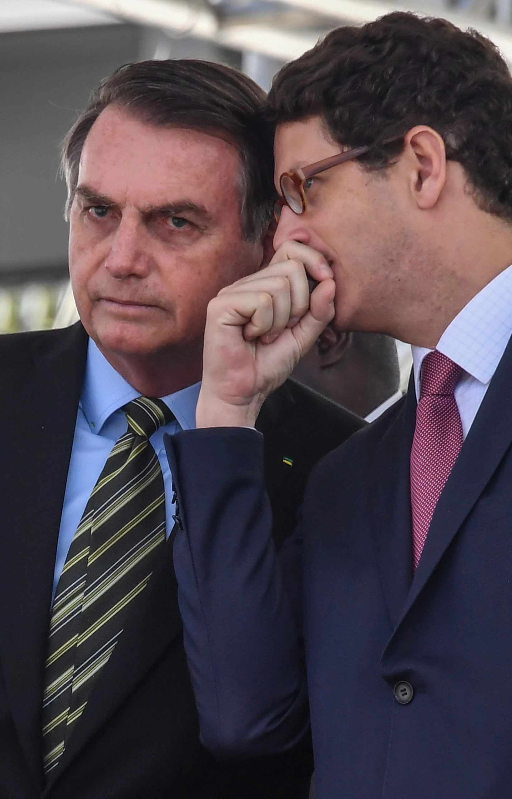 Brazilian President Jair Bolsonaro (L) listens to his Minister of the Environment Ricardo Salles, during a military event in Sao Paulo, Brazil on October 11, 2019.