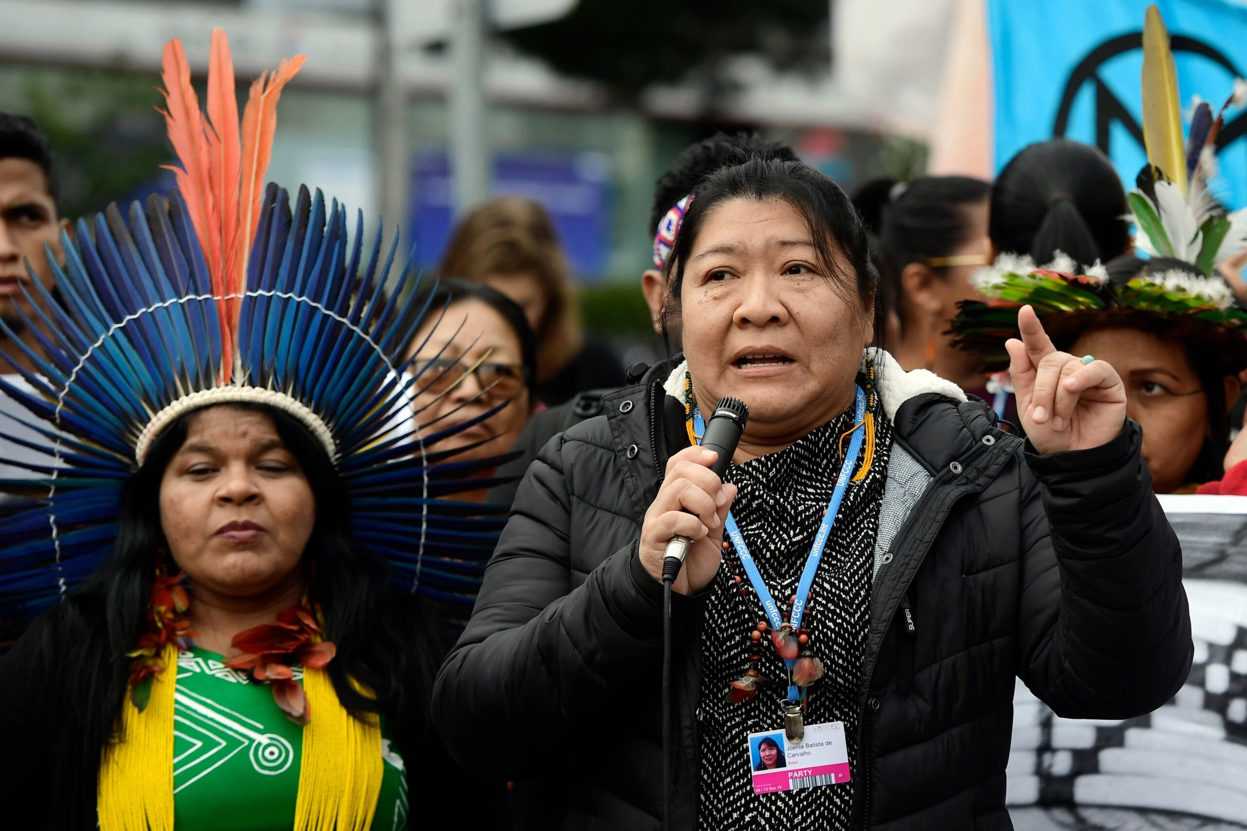 Indigenous rights defender, Brazilian lawyer Joenia Batista de Carvalho aka Joenia Wapichana (R) takes part in a demonstration demanding climate justice outside the venue of the UN Climate Change Conference COP25 at the 'IFEMA - Feria de Madrid' exhibition centre, in Madrid, on December 9, 2019. - The COP25 summit opened on December 2 with a stark warning from the UN about the "utterly inadequate" efforts of the world's major economies to curb carbon pollution, in Madrid, after the event's original host Chile withdrew last month due to deadly riots over economic inequality. (Photo by CRISTINA QUICLER / AFP) (Photo by CRISTINA QUICLER/AFP via Getty Images)