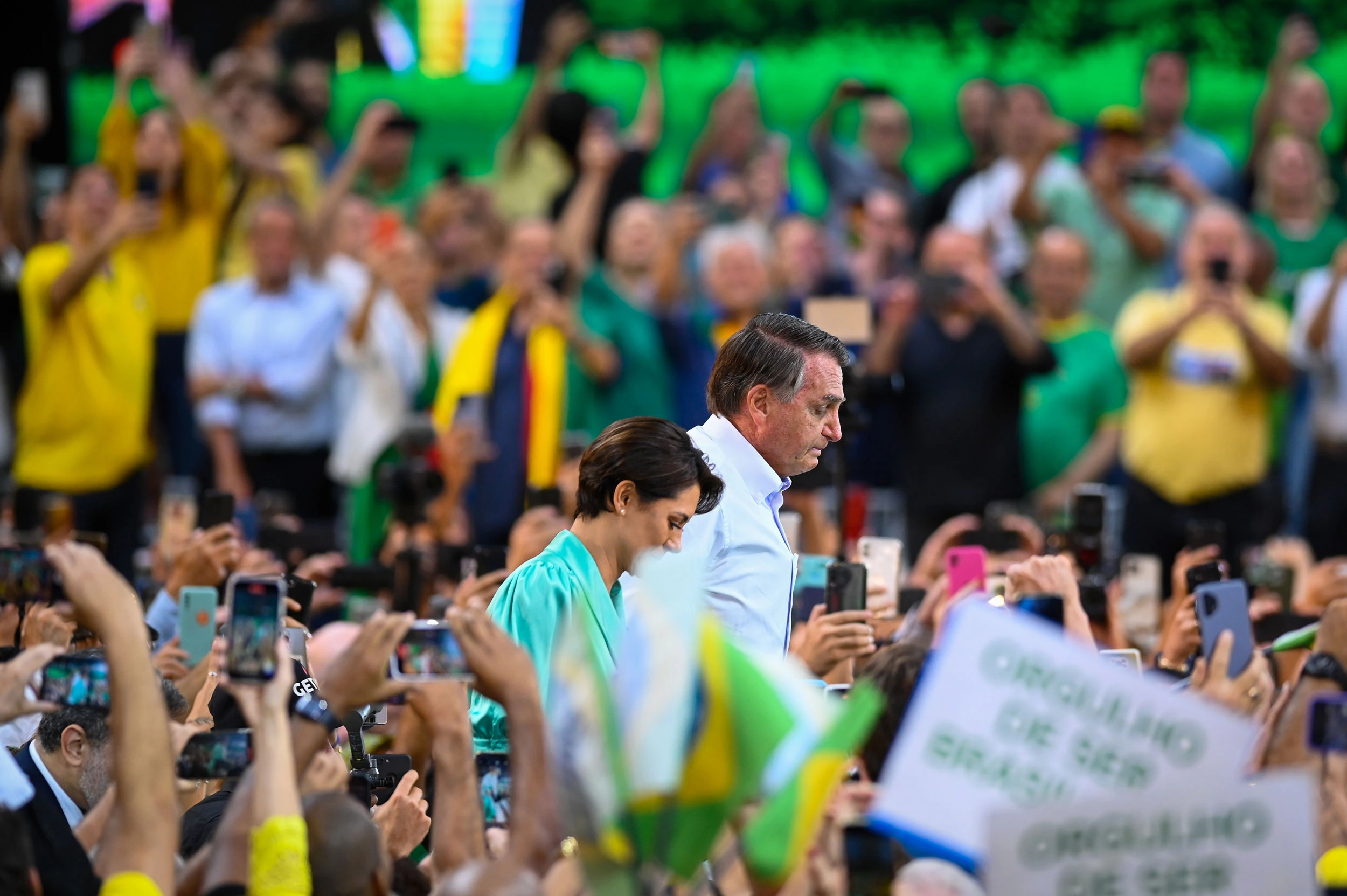 Jair Bolsonaro, Brazil's president, center, and First Lady Michele Bolsonaro attend the National Convention to formalize his candidacy for a second term, at Maracanazinho Gymnasium in Rio de Janeiro, Brazil, on Sunday, July 24, 2022. Bolsonaro officially kicked off his re-election campaign on Sunday, rallying thousands of his followers to Rio de Janeiro, after intensifying his attempts to discredit Brazil's voting system. Photographer: Andre Borges/Bloomberg via Getty Images