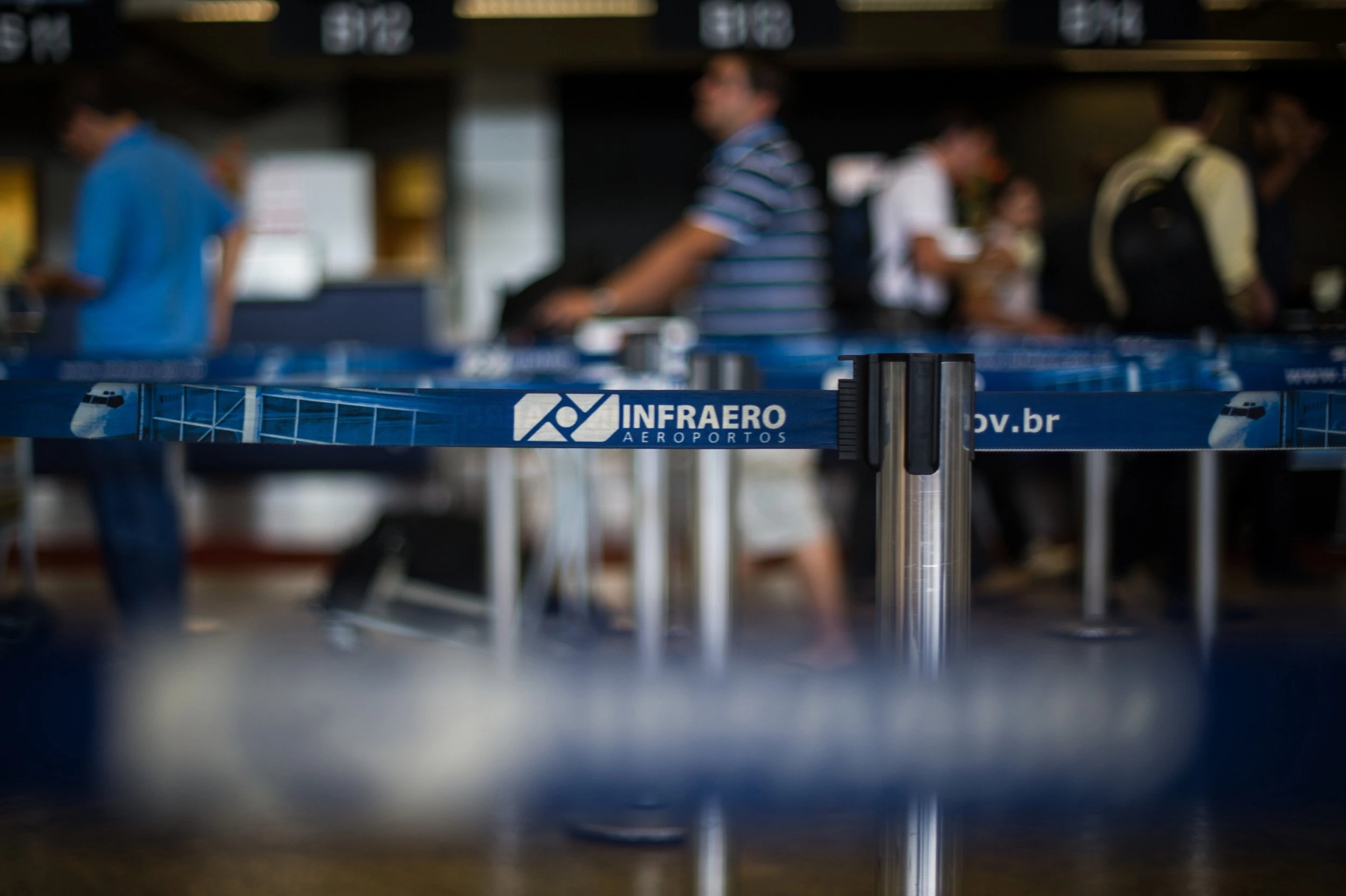 People make a line at the check-in counter of Guarulhos international airport, in Guarulhos, northern outskirts of Sao Paulo, Brazil, on February 6, 2012. The Brazilian government privatized three airports ahead of the 2014 World Cup, including Sao Paulo's Guarulhos, currently run by state-owned INFRAERO, through concessions valued at a total of $14 billion. AFP PHOTO / Yasuyoshi CHIBA (Photo credit should read YASUYOSHI CHIBA/AFP via Getty Images)