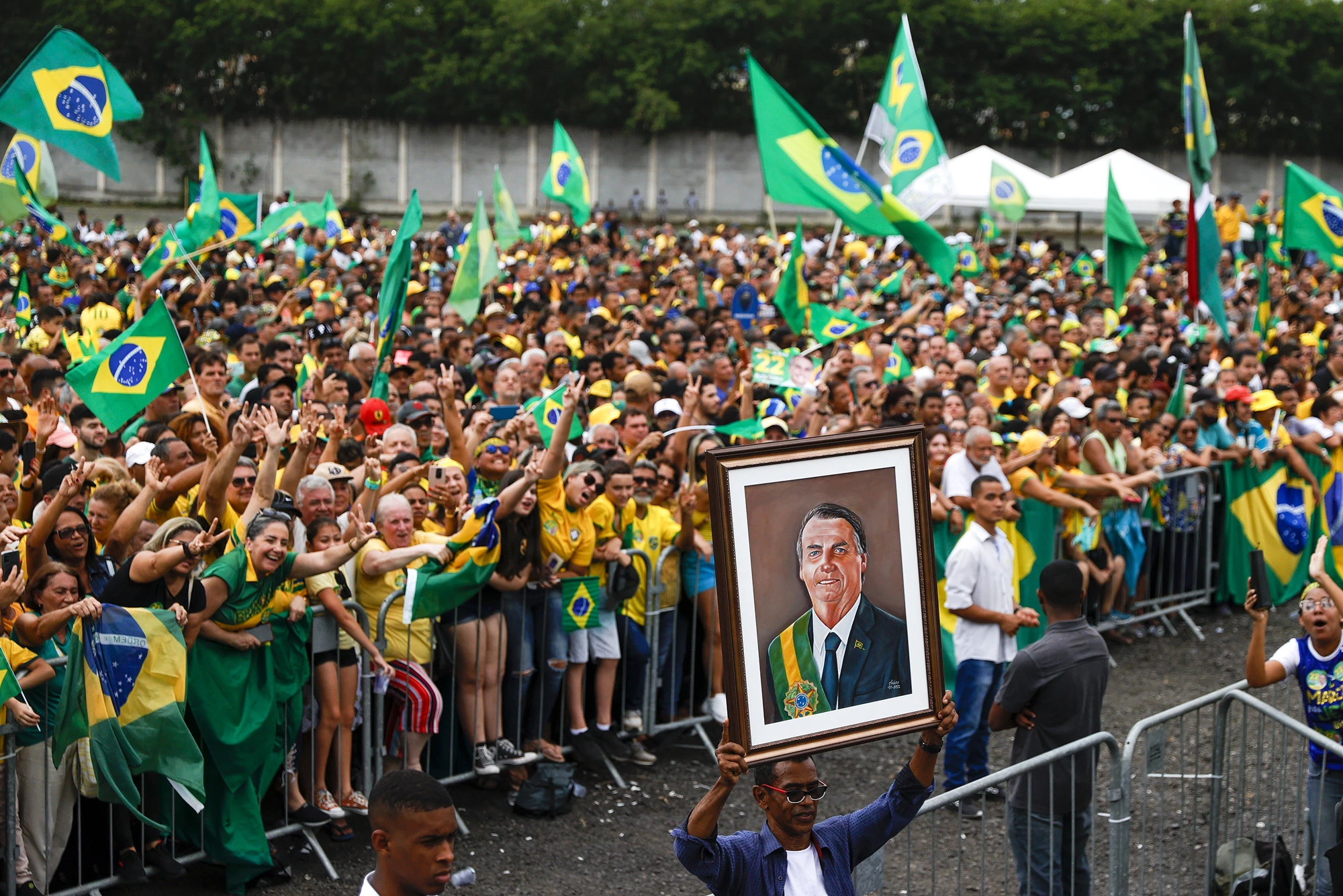 A supporter displays a painting of President of Brazil and presidential candidate Jair Bolsonaro during a rally organized by Liberal Party as part of the campaign ahead of presidential run-off on October 18, 2022 in Sao Goncalo, Brazil.