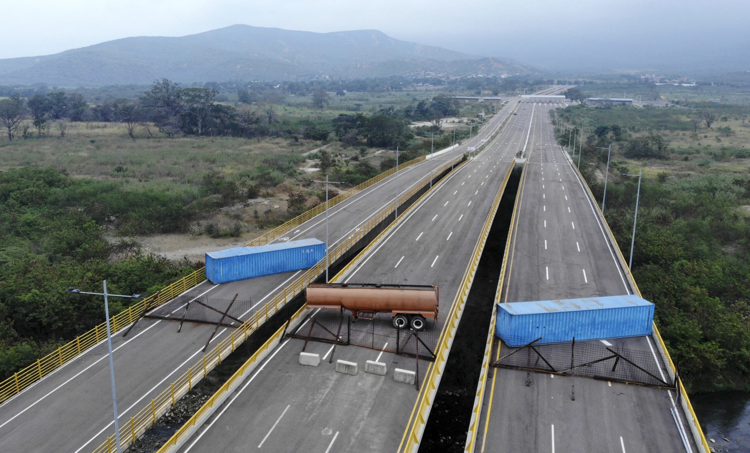 Aerial view of the Tienditas Bridge, in the border between Cucuta, Colombia and Tachira, Venezuela, after Venezuelan military forces blocked it with containers on February 6, 2019. - Venezuelan military officers blocked a bridge on the border with Colombia ahead of an anticipated humanitarian aid shipment, as opposition leader Juan Guaido stepped up his challenge to President Nicolas Maduro's authority. (Photo by EDINSON ESTUPINAN / AFP)        (Photo credit should read EDINSON ESTUPINAN/AFP/Getty Images)