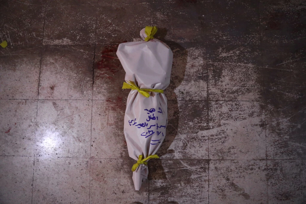 TOPSHOT - The body of a victim lies on the floor at a make-shift morgue following an airstrike in the rebel-held town of Douma, on the eastern outskirts of the capital Damascus, on November 10, 2016.At least 11 people including four children were killed on November 10 in air strikes on rebel-held areas near the Syrian capital, with one strike on the besieged town of Douma killing eight people including three children, according to the Syrian Observatory for Human Rights. / AFP / Abd Doumany        (Photo credit should read ABD DOUMANY/AFP/Getty Images)