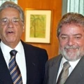 Brazilian newly elected president Luiz Inacio Lula da Silva (R) smiles as ruling president Fernando Henrique Cardoso jokes with the photographers, 29 October 2002, during a meeting at the presidential Palace in Brazilia, Brazil. Lula da Silva was elected with some 53 millions vote last 27 October, and will starts his governement period on January 2003.    AFP  PHOTO  Antonio SCORZA (Photo credit should read ANTONIO SCORZA/AFP/Getty Images)
