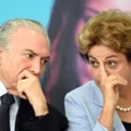 Brazilian President Dilma Rousseff (R) and Vice-President Michel Temer attend the launching ceremony of the Investment Program in Energy at Planalto Palace in Brasilia, on August 11, 2015. Analysts say Brazil's once booming economy suffers deep underlying illnesses, notably the massive corruption scandal unfolding at national oil company Petrobras and rippling across other top companies and into political circles. It is also on the brink of recession. According to a recent poll that put Rousseff's approval rating at eight percent, she is now Brazil's most unpopular democratically elected president since a military dictatorship ended in 1985.   AFP PHOTO / EVARISTO SA        (Photo credit should read EVARISTO SA/AFP/Getty Images)