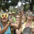 Demonstrators bange saucepans during a protest against Brazilian President Dilma Rousseff and the ruling Workers Party (PT) at Liberty Square in Belo Horizonte, Brazil on March 13, 2016. Protesters, many draped in the Brazilian national flag, poured into the streets  on Sunday at the start of mass demonstrations seeking to bring down President Dilma Rousseff. AFP PHOTO / Douglas MAGNO / AFP / Douglas Magno        (Photo credit should read DOUGLAS MAGNO/AFP/Getty Images)