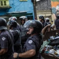 SAO PAULO, BRAZIL - FEBRUARY 23:  Military tactical police officers advance on suspected drug users in the region known as "Cracolandia" on February 23, 2017 in Sao Paulo, Brazil.  In an area of Brazil where drug abuse and violence has taken over the district, the government has introduced street clearance operations by police to remove the crack users. (Photo by Victor Moriyama/Getty Images)