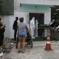 In this April 16, 2020 photo, Jonas Sena, suspected of suffering from COVID-19 disease, waits on a stretcher to be allowed in the 28 de Agosto hospital in Manaus, Amazonas state, Brazil. Manaus’ health care system, already strained before the coronavirus crisis, is buckling under the current onslaught of coronavirus patients. (AP Photo/Edmar Barros)