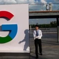 Homem passa diante de um logo do Google na Conferência Mundial de Inteligência Artificial em Xangai, na China, em 26 de setembro de 2018.