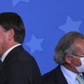 BRASILIA, BRAZIL - AUGUST 19: Jair Bolsonaro, President of Brazil (L) and Paulo Guedes Minister of Economy of Brazil (R) look on during a ceremony to sanction the provisional measure that facilitates access to bank credit at the Planalto Palace on August 19, 2020 in Brasilia, Brazil. The bill creates a credit program for individual microentrepreneurs, micro, small and medium-sized companies. The program's objective is, through guarantees, to facilitate the obtaining of loans by companies to mitigate the economic impacts of the Covid-19 pandemic. (Photo by Andre Borges/Getty Images) BRASILIA, BRAZIL - AUGUST 19: Jair Bolsonaro, President of Brazil (L) and Paulo Guedes Minister of Economy of Brazil (R) look on during a ceremony to sanction the provisional measure that facilitates access to bank credit at the Planalto Palace on August 19, 2020 in Brasilia, Brazil. The bill creates a credit program for individual microentrepreneurs, micro, small and medium-sized companies. The program's objective is, through guarantees, to facilitate the obtaining of loans by companies to mitigate the economic impacts of the Covid-19 pandemic. (Photo by Andre Borges/Getty Images)