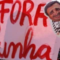 A supporter of Brazilian President Dilma Rousseff holds a balloon depicting the president of the Brazilian Social Democracy Party (PSDB) Aecio Neves and a sign reading "Cunha out" - referring to the president of the lower house of the Brazilian Congress Eduardo Cunha- during a demo in front of the National Congress in Brasilia, on April 17, 2016. Rousseff risks being driven from office if the lower house votes in favor of an impeachment trial Sunday. / AFP / BETO BARATA (Photo credit should read BETO BARATA/AFP/Getty Images)