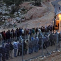 NI'ILIN, WEST BANK - JANUARY 03:  Palestinian labourers line up to cross an Israeli checkpoint as they return to their homes after a day's work in the Jewish state on January 3, 2010 near the village of Ni'ilin in the West Bank. Palestinians complain that the thousands of workers who have been granted coveted Israeli work permits find themselves waiting for hours without shelter and in all kinds of weather to cross the military checkpoints, leaving home hours before sunrise and returning late in the evening because of delays at the crossings.  (Photo by David Silverman/Getty Images)