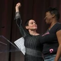 US actress Rose McGowan and Founder of #MeToo Campaign Tarana Burke, embrace on stage at the Women's March / Women's Convention in Detroit, Michigan, on October 27, 2017. A stream of actress including Rose McGowan, models and ex-employees have come out, many anonymously, to accuse Hollywood producer Harvey Weinstein of sexual harassment and abuse dating as far back as the 1990s. / AFP PHOTO / RENA LAVERTY (Photo credit should read RENA LAVERTY/AFP/Getty Images)