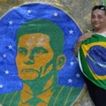 A woman stands next to an image of Brazilian judge Sergio Moro during a protest against suspended president Dilma Rousseff in Sao Paulo, on July 31, 2016.Protesters took to the streets of Brazil on Sunday to demand the final leaving of suspended President Dilma Rousseff or to defend her continuance, just five days before the start of the Rio 2016 Olympic Games. / AFP / NELSON ALMEIDA (Photo credit should read NELSON ALMEIDA/AFP/Getty Images)