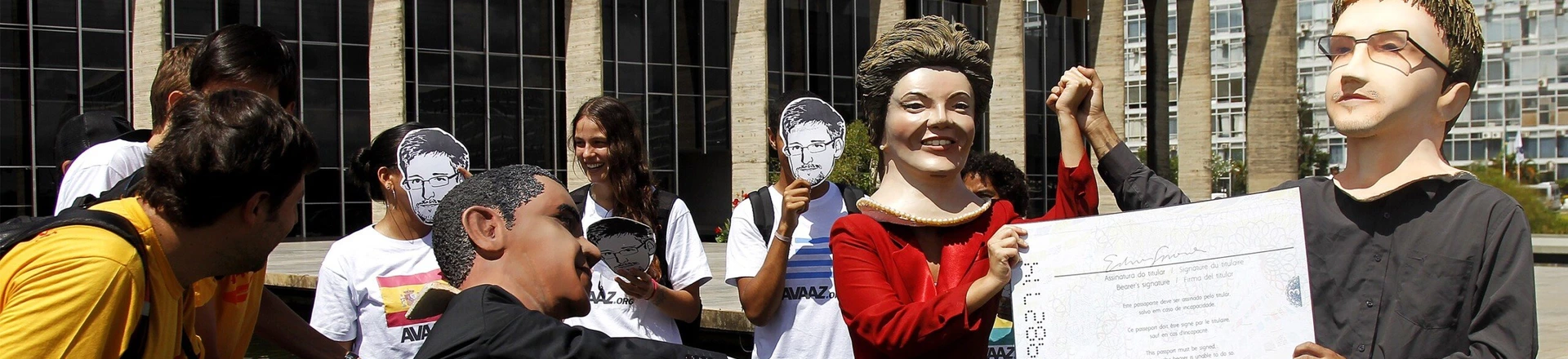Members of the Avaaz online community organization stage in front of the Itamaraty Forein Ministry Palace the delivery of the Brazilian passport by Brazilian President Dilma Rousseff to Edward Snowden while U.S. President Barack Obama tries to stop her, in Brasilia, on February 13, 2014. Avaaz members have collected over a million signatures in favor of the asylum application for Snowden, the former CIA technician  that disclosed the spying by the U.S. government to millions of people, among whom President Rousseff and German Chancellor Angela Merkel. AFP PHOTO/Beto BARATA        (Photo credit should read BETO BARATA/AFP/Getty Images) Members of the Avaaz online community organization stage in front of the Itamaraty Forein Ministry Palace the delivery of the Brazilian passport by Brazilian President Dilma Rousseff to Edward Snowden while U.S. President Barack Obama tries to stop her, in Brasilia, on February 13, 2014. Avaaz members have collected over a million signatures in favor of the asylum application for Snowden, the former CIA technician  that disclosed the spying by the U.S. government to millions of people, among whom President Rousseff and German Chancellor Angela Merkel. AFP PHOTO/Beto BARATA        (Photo credit should read BETO BARATA/AFP/Getty Images)