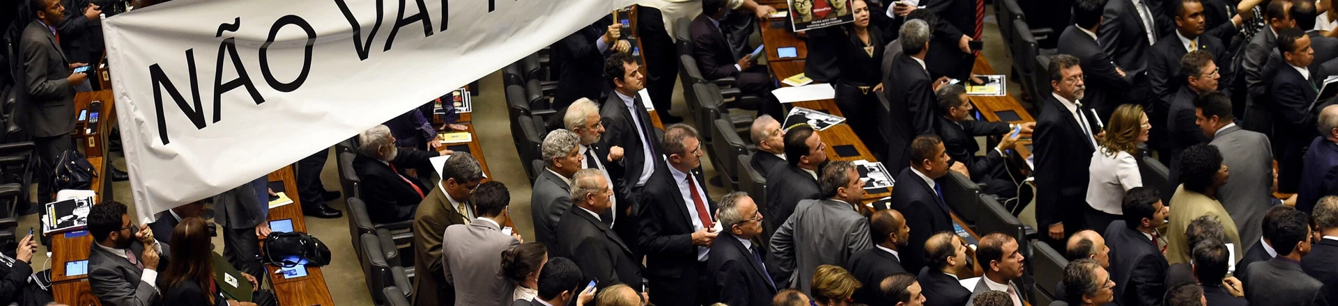 Brazilian pro-government deputies hold a banner reading "There will not be a coup" during the election of members for a special congressional commission that will be first up to analyze the impeachment case against President Dilma Rousseff, at the National Congress in Brasilia, on December 8, 2015. Pro-impeachment deputies got 39 out of 65 seats on the commission, which is tasked with making a recommendation to the full lower house on Rousseff's impeachment. AFP PHOTO/EVARISTO SA / AFP / EVARISTO SA        (Photo credit should read EVARISTO SA/AFP/Getty Images)