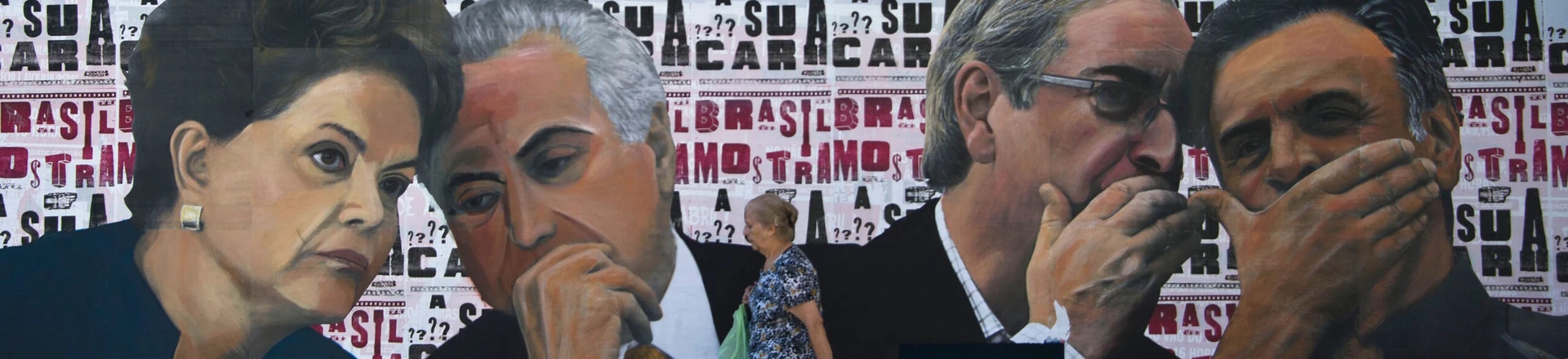 A woman walks past a mural depicting the president of the Brazilian lower house of Congress Eduardo Cunha (2-R) speaking with the president of the Brazilian Social Democracy Party (PSDB) Aecio Neves (R) as if they were conspiring against Brazilian President Dilma Rousseff (L), who is depicted speaking with Vice-President Michel Temer, at Paulista Avenue in Sao Paulo, Brazil on April 19, 2016.Brazil woke Monday to deep political crisis after lawmakers authorized impeachment proceedings against President Dilma Rousseff, sparking claims that democracy was under threat in Latin America's biggest country. / AFP / NELSON ALMEIDA (Photo credit should read NELSON ALMEIDA/AFP/Getty Images)