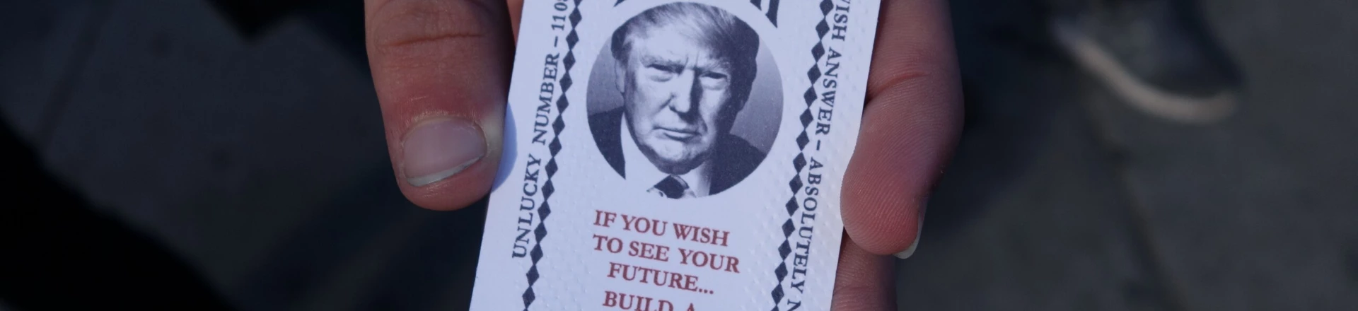 A man hold a card dispensed from the 'All-Seeing Trump', a fortune-telling fairground attraction bearing the likeness of Republican presidential candidate Donald Trump, in New York on October 12, 2016. There's little love for Donald Trump in his hometown these days, so New York has been both tickled and repelled by a fortune-telling, Trump-in-a-box mocking his offense-dishing campaign for president. The Trump-in-a-box has been made to resemble the Zoltar machine made famous in the 1988 Hollywood movie "Big" starring Tom Hanks. / AFP / William EDWARDS (Photo credit should read WILLIAM EDWARDS/AFP/Getty Images) A man hold a card dispensed from the 'All-Seeing Trump', a fortune-telling fairground attraction bearing the likeness of Republican presidential candidate Donald Trump, in New York on October 12, 2016. There's little love for Donald Trump in his hometown these days, so New York has been both tickled and repelled by a fortune-telling, Trump-in-a-box mocking his offense-dishing campaign for president. The Trump-in-a-box has been made to resemble the Zoltar machine made famous in the 1988 Hollywood movie "Big" starring Tom Hanks. / AFP / William EDWARDS (Photo credit should read WILLIAM EDWARDS/AFP/Getty Images)