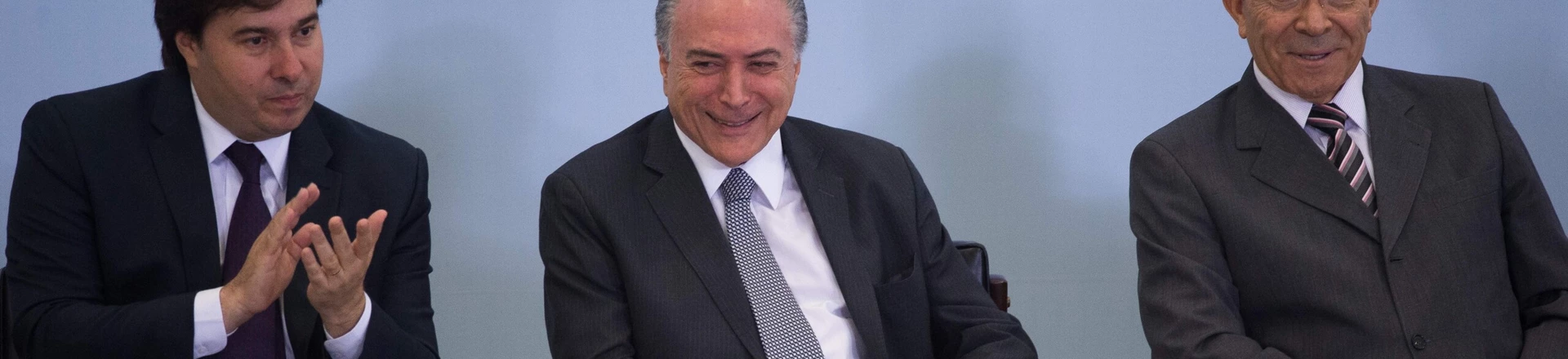 Brazilian President Michel Temer (C), Lower House President Rodrigo Maia and Chief of Staff Eliseu Padilha (R) attend a ceremony to promote new economy laws at Plantalto palace on October 27, 2016.Temer, who took over after the impeachment of Dilma Rousseff in August, urged an oil and gas conference in Rio de Janeiro to join what he said was an economy on the mend. / AFP / ANDRESSA ANHOLETE (Photo credit should read ANDRESSA ANHOLETE/AFP/Getty Images) Brazilian President Michel Temer (C), Lower House President Rodrigo Maia and Chief of Staff Eliseu Padilha (R) attend a ceremony to promote new economy laws at Plantalto palace on October 27, 2016.Temer, who took over after the impeachment of Dilma Rousseff in August, urged an oil and gas conference in Rio de Janeiro to join what he said was an economy on the mend. / AFP / ANDRESSA ANHOLETE (Photo credit should read ANDRESSA ANHOLETE/AFP/Getty Images)