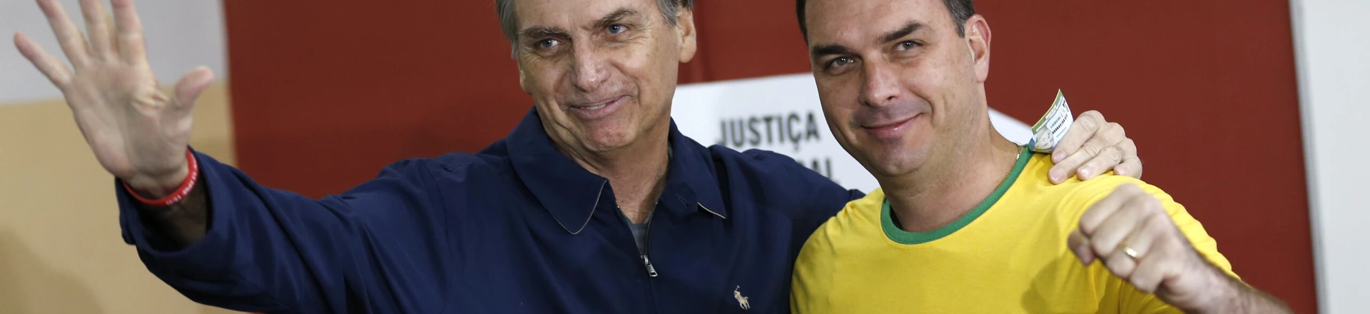 FILE - In this Oct. 7, 2018 file photo, then presidential frontrunner Jair Bolsonaro, left, and his son Flavio, acknowledge reporters at a polling station in Rio de Janeiro, Brazil. The son of Brazilian President-elect Jair Bolsonaro is denying wrongdoing in a case involving suspect bank transactions. According to a recent Financial Activities Control Council report, Flavio Bolsonaro's driver deposited various amounts between January 2016 and January 2017. On Thursday, Dec. 13, 2018, Flavio Bolsonaro posted on Twitter that he had “done nothing wrong.” (AP Photo/Silvia Izquierdo, File) FILE - In this Oct. 7, 2018 file photo, then presidential frontrunner Jair Bolsonaro, left, and his son Flavio, acknowledge reporters at a polling station in Rio de Janeiro, Brazil. The son of Brazilian President-elect Jair Bolsonaro is denying wrongdoing in a case involving suspect bank transactions. According to a recent Financial Activities Control Council report, Flavio Bolsonaro's driver deposited various amounts between January 2016 and January 2017. On Thursday, Dec. 13, 2018, Flavio Bolsonaro posted on Twitter that he had “done nothing wrong.” (AP Photo/Silvia Izquierdo, File)
