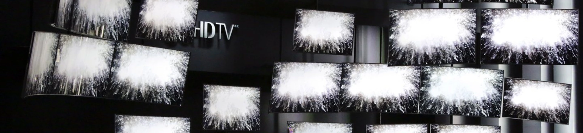 FILE - In this Thursday, Jan. 8, 2015, file photo, attendees watch a presentation at the Samsung booth at the International CES, in Las Vegas. For years, TV makers have focused on making pictures sharper by squeezing more pixels onto screens, but now their attention is shifting to improving the way sets display color, with a newish technology called HDR taking center stage. (AP Photo/Jae C. Hong, File) FILE - In this Thursday, Jan. 8, 2015, file photo, attendees watch a presentation at the Samsung booth at the International CES, in Las Vegas. For years, TV makers have focused on making pictures sharper by squeezing more pixels onto screens, but now their attention is shifting to improving the way sets display color, with a newish technology called HDR taking center stage. (AP Photo/Jae C. Hong, File)