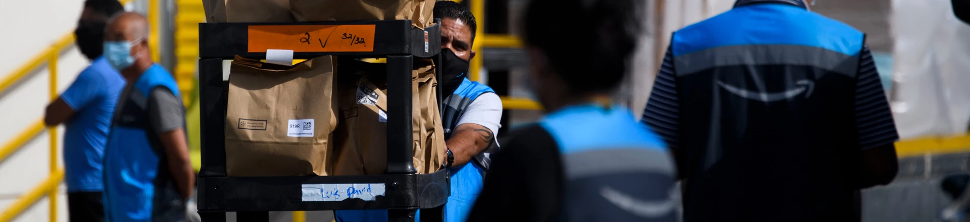 An Amazon.com Inc. delivery driver pushes a cart of groceries to load into a vehicle outside of a distribution facility on February 2, 2021 in Redondo Beach, California. - Jeff Bezos said February 1, 2021, he would give up his role as chief executive of Amazon later this year as the tech and e-commerce giant reported a surge in profit and revenue in the holiday quarter. The announcement came as Amazon reported a blowout holiday quarter with profits more than doubling to $7.2 billion and revenue jumping 44 percent to $125.6 billion. (Photo by Patrick T. FALLON / AFP) (Photo by PATRICK T. FALLON/AFP via Getty Images) An Amazon.com Inc. delivery driver pushes a cart of groceries to load into a vehicle outside of a distribution facility on February 2, 2021 in Redondo Beach, California. - Jeff Bezos said February 1, 2021, he would give up his role as chief executive of Amazon later this year as the tech and e-commerce giant reported a surge in profit and revenue in the holiday quarter. The announcement came as Amazon reported a blowout holiday quarter with profits more than doubling to $7.2 billion and revenue jumping 44 percent to $125.6 billion. (Photo by Patrick T. FALLON / AFP) (Photo by PATRICK T. FALLON/AFP via Getty Images)