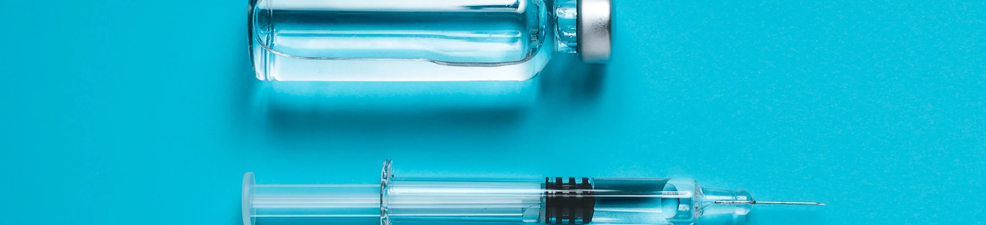 Syringe and ampoule on blue background Syringe and ampoule on blue background