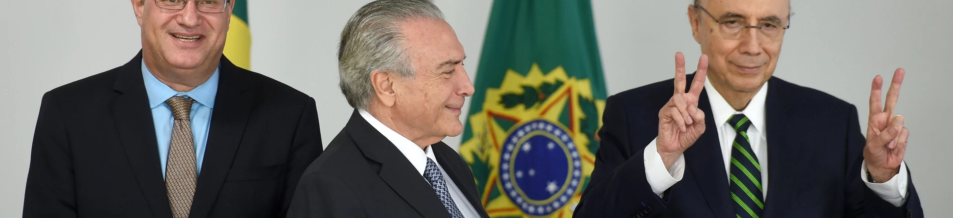 Brazilian acting President Michel Temer (C), Finance Minister Henrique Meirelles (R) and Ilan Goldfajn, appointed president to the Central Bank pose for photographers during a meeting at Planalto Palace in Brasilia on May 17, 2016. / AFP / EVARISTO SA        (Photo credit should read EVARISTO SA/AFP/Getty Images)