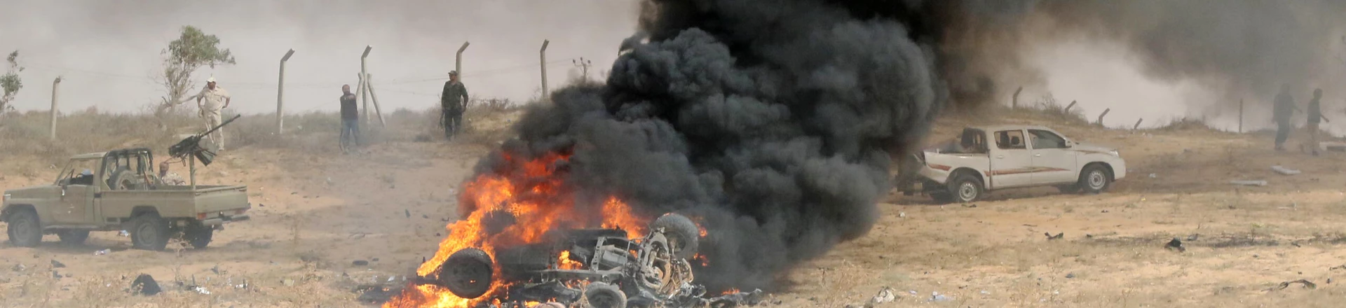 Forces loyal to Libya's UN-backed unity government gather at the site of a car-bomb attack carried out by an Islamic State (IS) group jihadist at the western entrance of Sirte on June 2, 2016.
According to Libyan officials fighting resumed on June 1 on the outskirts of Sirte between their forces and jihadist during which three pro-government troops had been killed and 10 more wounded. Sirte was the hometown of slain dictator Moamer Kadhafi and, since seizing it in June last year, IS has turned it into a recruitment and training camp / AFP / MAHMUD TURKIA        (Photo credit should read MAHMUD TURKIA/AFP/Getty Images)