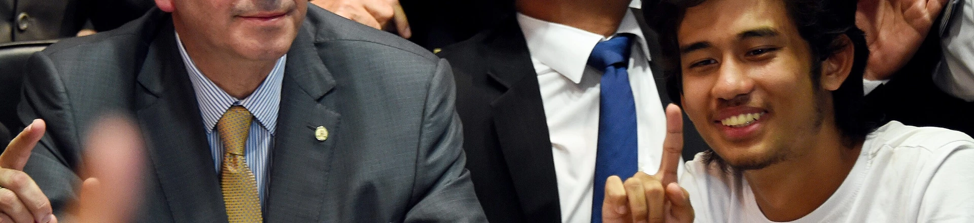 Kim Kataguiri (R), leader of the Free Brazil Movement (MBL), meets with Brazilian Lower House President Eduardo Cunha in Brasilia, Brazil on May 27, 2015. Kataguiri, a 19-year-old college drop out, is the face of MBL, a growing force which seeks to harness some of the energy of the 2013 protest movement which brought more than a million onto the streets. AFP PHOTO/EVARISTO SA        (Photo credit should read EVARISTO SA/AFP/Getty Images) Kim Kataguiri (R), leader of the Free Brazil Movement (MBL), meets with Brazilian Lower House President Eduardo Cunha in Brasilia, Brazil on May 27, 2015. Kataguiri, a 19-year-old college drop out, is the face of MBL, a growing force which seeks to harness some of the energy of the 2013 protest movement which brought more than a million onto the streets. AFP PHOTO/EVARISTO SA        (Photo credit should read EVARISTO SA/AFP/Getty Images)