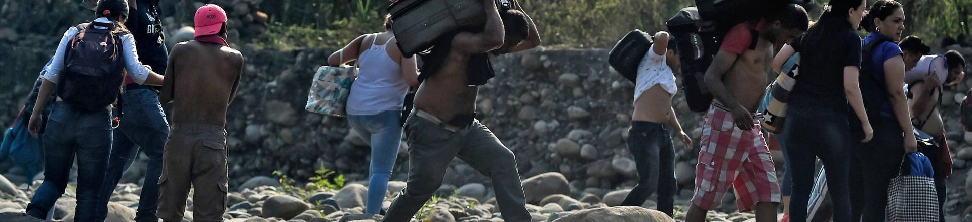 People taking irregular roads cross the Tachira river from Cucuta in Colombia to San Antonio del Tachira in Venezuela, near the Simon Bolivar international Bridge, on February 25, 2019. - United States Vice President Mike Pence told Venezuelan opposition leader Juan Guaido that Donald Trump supports him "100 percent" as the pair met regional allies on Monday to thrash out a strategy to remove Nicolas Maduro from power after the failed attempt to ship in humanitarian aid. (Photo by Luis ROBAYO / AFP)        (Photo credit should read LUIS ROBAYO/AFP/Getty Images) People taking irregular roads cross the Tachira river from Cucuta in Colombia to San Antonio del Tachira in Venezuela, near the Simon Bolivar international Bridge, on February 25, 2019. - United States Vice President Mike Pence told Venezuelan opposition leader Juan Guaido that Donald Trump supports him "100 percent" as the pair met regional allies on Monday to thrash out a strategy to remove Nicolas Maduro from power after the failed attempt to ship in humanitarian aid. (Photo by Luis ROBAYO / AFP)        (Photo credit should read LUIS ROBAYO/AFP/Getty Images)