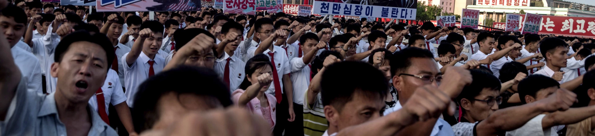 People wave banners and shout slogans as they attend a rally in support of North Korea's stance against the US, on Kim Il-Sung square in Pyongyang on August 9, 2017. 
US President Donald Trump said the United States' nuclear arsenal was "more powerful than ever" in a fresh warning to North Korea over its repeated missile tests. / AFP PHOTO / KIM Won-Jin        (Photo credit should read KIM WON-JIN/AFP/Getty Images)