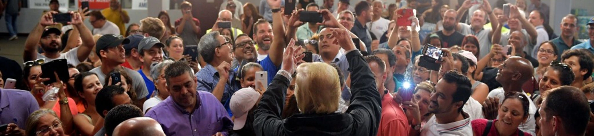 US President Donald Trump takes part in a food and suplly distribution at the Cavalry Chapel in Guaynabo, Puerto Rico on October 3, 2017.Nearly two weeks after Hurricane Maria thrashed through the US territory, much of the islands remains short of food and without access to power or drinking water. / AFP PHOTO / MANDEL NGAN (Photo credit should read MANDEL NGAN/AFP/Getty Images) US President Donald Trump takes part in a food and suplly distribution at the Cavalry Chapel in Guaynabo, Puerto Rico on October 3, 2017.Nearly two weeks after Hurricane Maria thrashed through the US territory, much of the islands remains short of food and without access to power or drinking water. / AFP PHOTO / MANDEL NGAN (Photo credit should read MANDEL NGAN/AFP/Getty Images)