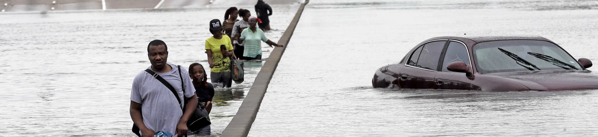 Evacuees wade down a flooded section of Interstate 610 as floodwaters from Tropical Storm Harvey rise Sunday, Aug. 27, 2017, in Houston. The remnants of Hurricane Harvey sent devastating floods pouring into Houston Sunday as rising water chased thousands of people to rooftops or higher ground. (AP Photo/David J. Phillip) Evacuees wade down a flooded section of Interstate 610 as floodwaters from Tropical Storm Harvey rise Sunday, Aug. 27, 2017, in Houston. The remnants of Hurricane Harvey sent devastating floods pouring into Houston Sunday as rising water chased thousands of people to rooftops or higher ground. (AP Photo/David J. Phillip)