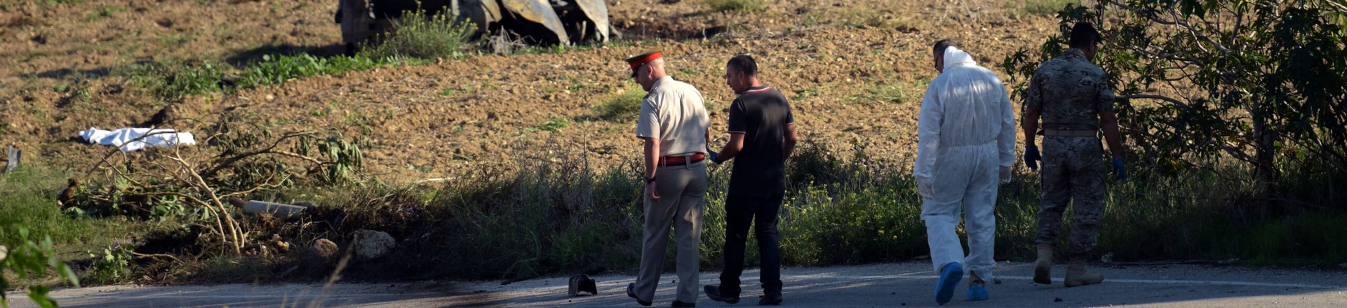 TOPSHOT - Police and forensic experts inspect the wreckage of a car bomb believed to have killed journalist and blogger Daphne Caruana Galizia close to her home in Bidnija, Malta, on October 16, 2017. The force of the blast broke her car into several pieces and catapulted the journalist's body into a nearby field, witnesses said. She leaves a husband and three sons.
Caruana Galizia's death comes four months after Prime Minister Joseph Muscat's Labour Party won a resounding victory in a general election he called early as a result of scandals to which Caruana Galizia's allegations were central. / AFP PHOTO / STR / Malta OUT (Photo credit should read STR/AFP/Getty Images) TOPSHOT - Police and forensic experts inspect the wreckage of a car bomb believed to have killed journalist and blogger Daphne Caruana Galizia close to her home in Bidnija, Malta, on October 16, 2017. The force of the blast broke her car into several pieces and catapulted the journalist's body into a nearby field, witnesses said. She leaves a husband and three sons.
Caruana Galizia's death comes four months after Prime Minister Joseph Muscat's Labour Party won a resounding victory in a general election he called early as a result of scandals to which Caruana Galizia's allegations were central. / AFP PHOTO / STR / Malta OUT (Photo credit should read STR/AFP/Getty Images)