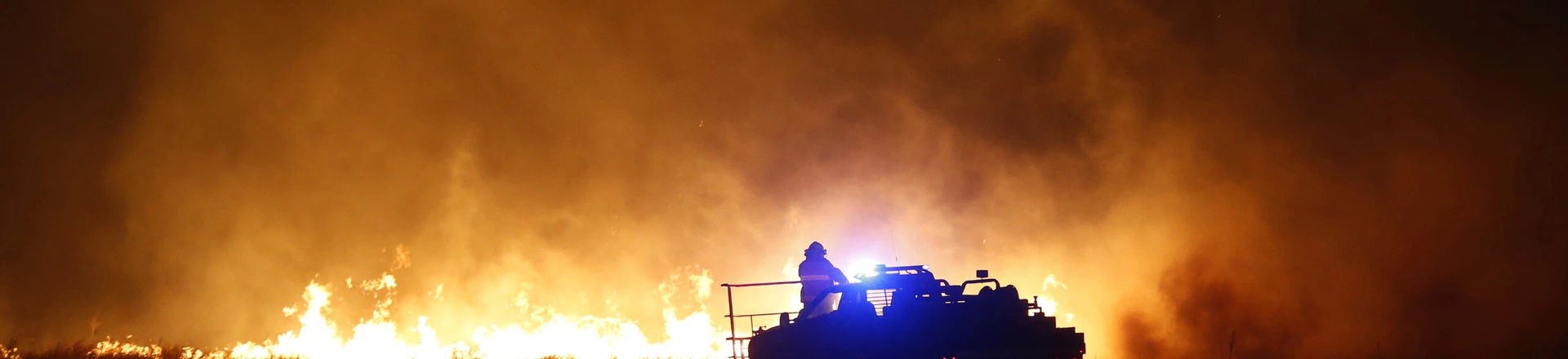 Firefighters from across Kansas and Oklahoma battle a wildfire near Protection, Kan., Monday, March 6, 2017. (Bo Rader/The Wichita Eagle via AP) Firefighters from across Kansas and Oklahoma battle a wildfire near Protection, Kan., Monday, March 6, 2017. (Bo Rader/The Wichita Eagle via AP)