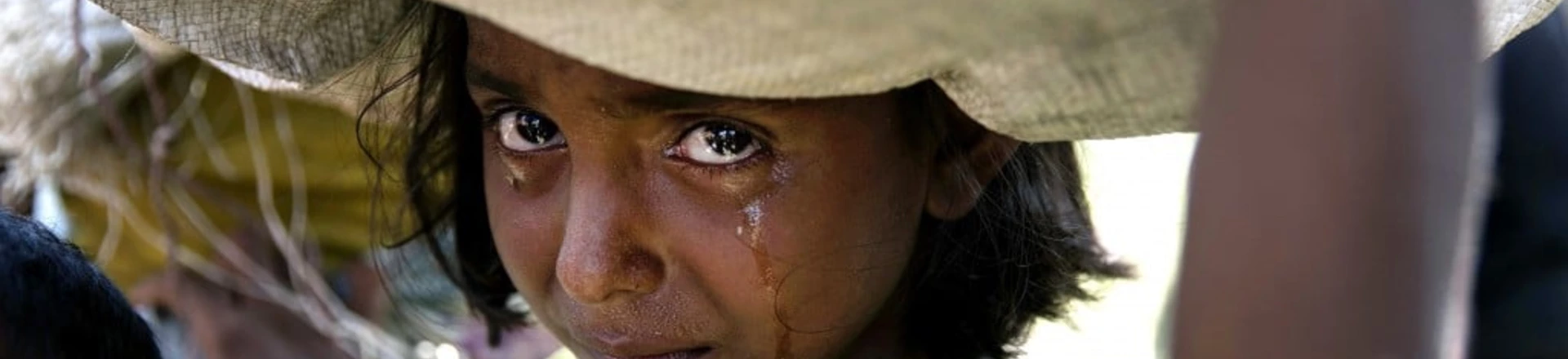 PALONG KHALI, BANGLADESH - OCTOBER 16: A Rohingya girl cries as refugees fleeing from Myanmar cross a stream in the hot sun on a muddy rice field on October 16, 2017 near Palang Khali, Cox's Bazar, Bangladesh. Well over a half a million Rohingya refugees have fled into Bangladesh since late August during the outbreak of violence in Rakhine state causing a humanitarian crisis in the region with continued challenges for aid agencies. (Photo by Paula Bronstein/Getty Images) PALONG KHALI, BANGLADESH - OCTOBER 16: A Rohingya girl cries as refugees fleeing from Myanmar cross a stream in the hot sun on a muddy rice field on October 16, 2017 near Palang Khali, Cox's Bazar, Bangladesh. Well over a half a million Rohingya refugees have fled into Bangladesh since late August during the outbreak of violence in Rakhine state causing a humanitarian crisis in the region with continued challenges for aid agencies. (Photo by Paula Bronstein/Getty Images)