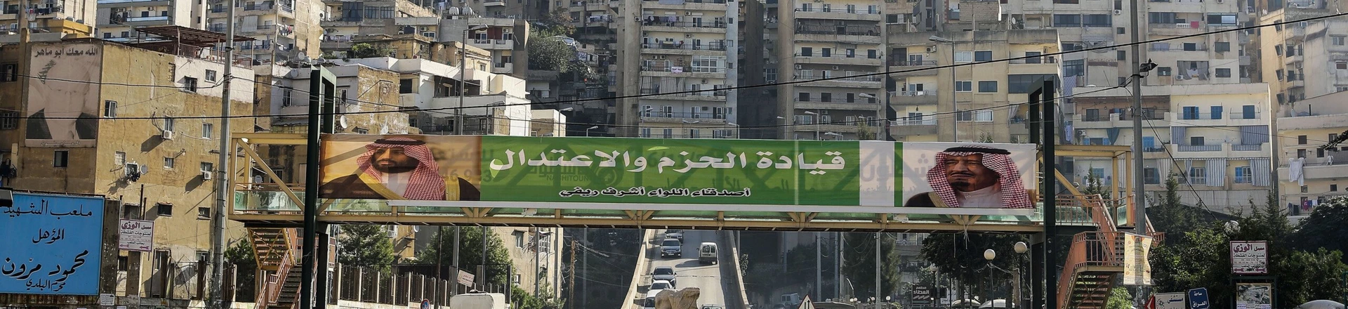 A picture taken on November 10, 2017 shows a banner bearing the images of Saudi King Salman bin Abdulaziz (R) and Crown Prince Mohammed bin Salman (L) hanging on a pedestrian crossing bridge in the northern Lebanese port city of Tripoli, between them a caption reading in Arabic "firm and moderating leadership", days after Lebanese Prime Minister Saad Hariri announced his resignation during a televised speech airing from the Saudi capital Riyadh.Hariri's announced resignation sparked concerns of a political crisis in Lebanon as tensions between Saudi Arabia and Iran escalated. / AFP PHOTO / JOSEPH EID (Photo credit should read JOSEPH EID/AFP/Getty Images)