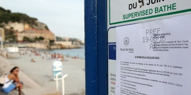 This picture taken on August 19, 2016 shows the bylaw forbidding women to wear Burkini at the beach in Nice, southeastern France on August 19, 2016. 
Nice has become the latest French seaside resort to ban the burkini, the body-concealing Islamic swimsuit that has sparked heated debate in secular France. Using language similar to bans imposed in a string of other towns on the French Riviera, the city barred apparel that "overtly manifests adherence to a religion at a time when France and places of worship are the target of terrorist attacks".
 / AFP / JEAN CHRISTOPHE MAGNENET        (Photo credit should read JEAN CHRISTOPHE MAGNENET/AFP/Getty Images)